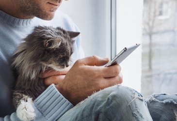 Man and cat with pet insurance